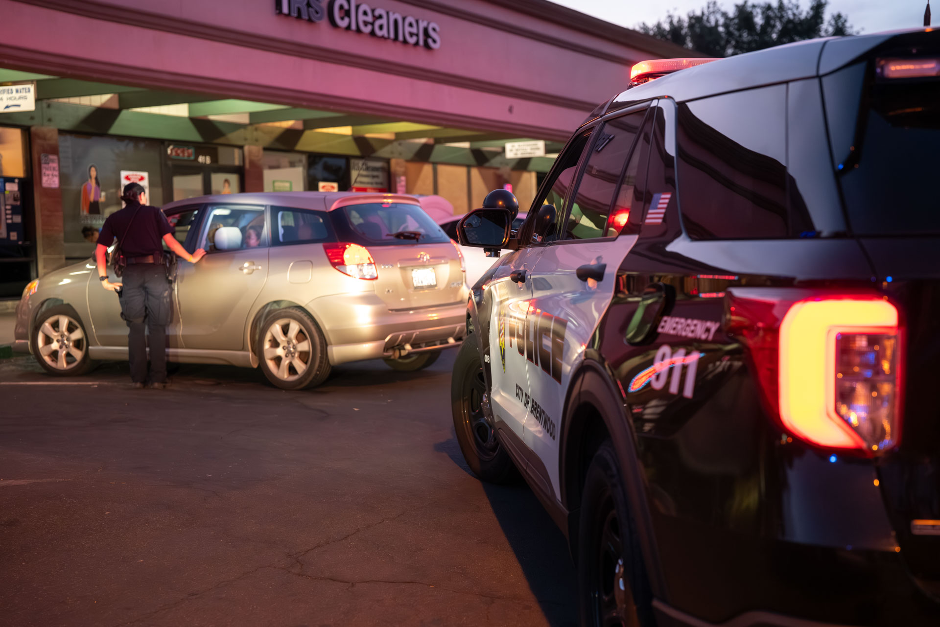 Traffic stop outside a Brentwood storefront at dusk
